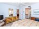 Spacious bedroom with dresser, view of dining area, and ensuite bath at 454 Cerromar Rd # 275, Venice, FL 34293