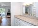 Bright bathroom with vanity, granite countertop, and large mirror at 454 Cerromar Rd # 275, Venice, FL 34293