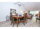 Dining area with a wooden table and teal chairs at 454 Cerromar Rd # 275, Venice, FL 34293