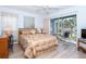 Bedroom with a queen bed, balcony access, and light flooring at 454 Cerromar Rd # 275, Venice, FL 34293