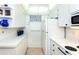 White kitchen with appliances and ample cabinet space at 454 Cerromar Rd # 275, Venice, FL 34293