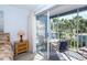 Private screened balcony with table and chairs, overlooking tropical landscape at 454 Cerromar Rd # 275, Venice, FL 34293