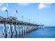 Long pier extending into the ocean with American flag at 454 Cerromar Rd # 275, Venice, FL 34293