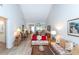 Living room with floral couches, coffee table and view into kitchen and dining area at 454 Cerromar Rd # 275, Venice, FL 34293