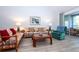 Living room features floral couches, coffee table and teal armchair at 454 Cerromar Rd # 275, Venice, FL 34293
