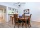 Bright dining room with wood table and chairs, kitchen pass-through at 454 Cerromar Rd # 275, Venice, FL 34293