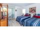 Guest bedroom with two twin beds, and access to balcony at 454 Cerromar Rd # 275, Venice, FL 34293