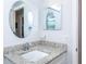 Bright bathroom vanity with granite countertop and mirror at 454 Cerromar Rd # 275, Venice, FL 34293
