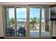 Private balcony with seating offers stunning views of the beach and palm trees at 361 Benjamin Franklin Dr # A, Sarasota, FL 34236