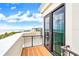 Balcony with wood flooring and black metal railings offers a relaxing space with ocean views at 361 Benjamin Franklin Dr # A, Sarasota, FL 34236