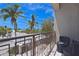 Relaxing balcony with comfortable seating, offering stunning views of the beach and palm trees at 361 Benjamin Franklin Dr # A, Sarasota, FL 34236