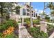 Elegant multi-story home with lush landscaping, featuring a paved walkway and a beautifully maintained garden at 361 Benjamin Franklin Dr # A, Sarasota, FL 34236