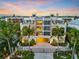 Stunning beachfront property with tropical landscaping, gated entry, and rooftop pool offering luxurious coastal living at 361 Benjamin Franklin Dr # A, Sarasota, FL 34236