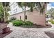 Landscaped brick walkway with pavers and tropical plants and trees at 361 Benjamin Franklin Dr # A, Sarasota, FL 34236