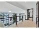 Hallway view with glass railings, large windows, and tile flooring at 361 Benjamin Franklin Dr # A, Sarasota, FL 34236