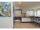Modern kitchen featuring stainless steel appliances, a center island with seating, and stylish backsplash at 361 Benjamin Franklin Dr # A, Sarasota, FL 34236