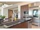 Modern kitchen featuring stainless steel appliances, dark countertops, and a stylish island with seating at 361 Benjamin Franklin Dr # A, Sarasota, FL 34236
