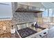 Close-up of a kitchen featuring a Wolf gas range, stainless steel hood, and stylish backsplash at 361 Benjamin Franklin Dr # A, Sarasota, FL 34236