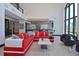 Bright open-concept living area with stylish furniture, and large windows at 361 Benjamin Franklin Dr # A, Sarasota, FL 34236