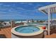 Rooftop deck boasts dual hot tubs, ocean views, and sun-soaked relaxation at 361 Benjamin Franklin Dr # A, Sarasota, FL 34236
