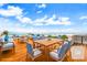 Rooftop terrace features wood floors and dining and seating areas with stunning ocean views at 361 Benjamin Franklin Dr # A, Sarasota, FL 34236