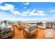 Relaxing rooftop terrace with wood floors and comfortable seating areas with ocean views at 361 Benjamin Franklin Dr # A, Sarasota, FL 34236
