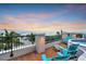 Rooftop terrace features lounge seating, a hot tub, and captivating sunset views over the water at 361 Benjamin Franklin Dr # A, Sarasota, FL 34236