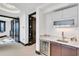 Home wet bar with granite countertop, mini-fridge, and sleek cabinetry for effortless entertaining at 361 Benjamin Franklin Dr # A, Sarasota, FL 34236