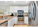 Modern kitchen with stainless steel appliances and light wood cabinets at 744 White Pine Tree Rd # 103, Venice, FL 34285