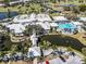 Aerial view of the Augusta Villas clubhouse featuring a pool, water features and golf course at 266 Cerromar S Way # 55, Venice, FL 34293