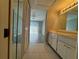 Bathroom with tile floors, single sink vanity, and a view into the bedroom at 266 Cerromar S Way # 55, Venice, FL 34293