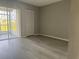 This bedroom has hard surface floors, closet, and screened porch access at 266 Cerromar S Way # 55, Venice, FL 34293