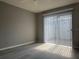 This bedroom features hard surface floors, ceiling fan, and sliding door at 266 Cerromar S Way # 55, Venice, FL 34293