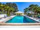 Sparkling community pool surrounded by mature palm trees and plenty of lounge chairs for residents at 266 Cerromar S Way # 55, Venice, FL 34293