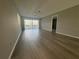 Spacious living room featuring wood floors and sliding glass doors to the lanai at 266 Cerromar S Way # 55, Venice, FL 34293