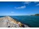 View of the ocean from a rocky path with a clear blue sky at 266 Cerromar S Way # 55, Venice, FL 34293