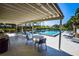 Covered pool area with lounge seating; ideal for relaxation and socializing in the Augusta Villa community at 266 Cerromar S Way # 55, Venice, FL 34293