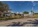 View of the community clubhouse and surrounding landscape at 448 Cerromar Rd # 286, Venice, FL 34293