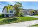 One-story home with neutral exterior and landscaping at 19728 Tortuga Cay Dr, Venice, FL 34293