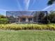 Enclosed pool area with lush landscaping at 205 Mestre Pl, North Venice, FL 34275