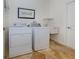 Convenient laundry room with washer, dryer, and utility sink at 205 Mestre Pl, North Venice, FL 34275