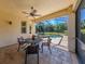 Covered patio with table and chairs, overlooking a refreshing pool at 205 Mestre Pl, North Venice, FL 34275
