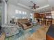 Open living room with kitchen view, leather sofas, and area rug at 205 Mestre Pl, North Venice, FL 34275