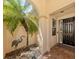 Front entry with arched entryway, palm tree, and bird statue at 205 Mestre Pl, North Venice, FL 34275
