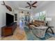 Spacious living room with comfy seating, large TV, and access to patio at 205 Mestre Pl, North Venice, FL 34275
