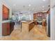 Open kitchen with island, stainless steel appliances, and wood cabinets at 205 Mestre Pl, North Venice, FL 34275