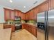 Modern kitchen with stainless steel appliances and wood cabinets at 205 Mestre Pl, North Venice, FL 34275