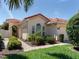 Front entrance with a walkway and lush landscaping at 205 Mestre Pl, North Venice, FL 34275