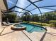 Relaxing screened pool and spa with plenty of patio space at 205 Mestre Pl, North Venice, FL 34275