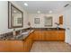 Bathroom with granite countertops, double sinks, and large mirror at 601 Shreve St # 51B, Punta Gorda, FL 33950